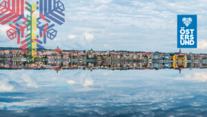 spegelblank sjö med östersunds skyline som speglar sig